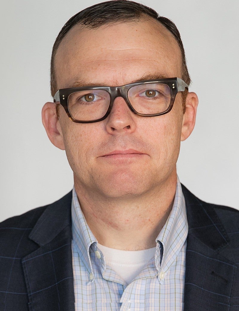 Headshot of the new FSU Dean of The Graduate School, Gregory Bell, wearing glasses in a suit jacket.